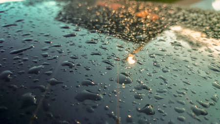 Many of raindrops stuck on the windshield background. Abstract of raindrops on the mirror made with color filtersの写真素材