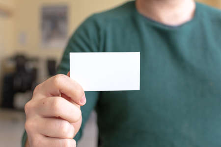 Business Card Mock-Up - Man Holding a Blank Card for Clients. Business Card Template.の写真素材