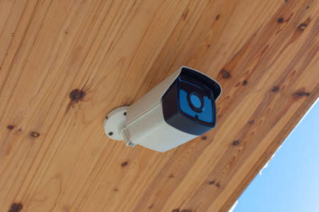 Modern Outdoor CCTV Camera on a Ceiling. Concept of Surveillance and Monitoring. Surveillance camera...