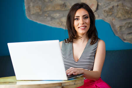 Happy Young Stylish Woman Using Laptop.の写真素材