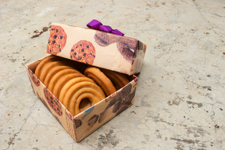 Brown Gift Box With cookies inside on Old Cement Floorの写真素材