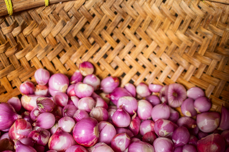 Peeled Onions on Indonesia Traditional Bamboo Basket. Onion is Ingredient Food in Indonesia.の写真素材
