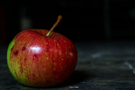Still Life Fresh Red Green Apple on Dark Moody Backgroundの写真素材