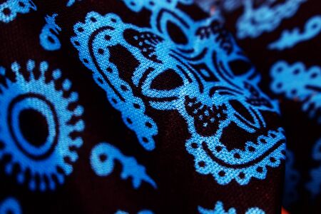 Abstract Background Close Up Blue Batik pattern on Black fabricの写真素材