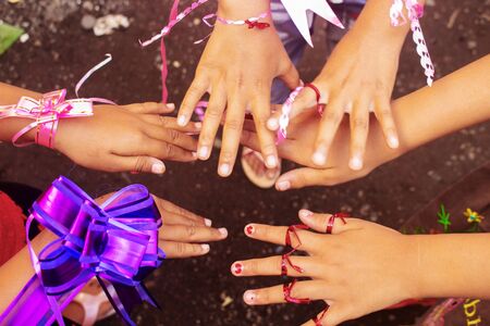 Close up Asian Little Girls Wear Colorful String on Handの写真素材