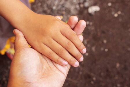 Top Down View Asian Adult Hold Asian Little Girl Handの写真素材