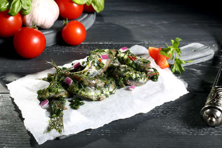 anchovies marinated on white paper gray background
