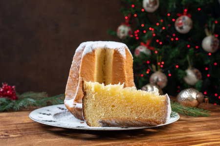 Christmas cake with icing sugar on a wooden background. Selective focus.の写真素材
