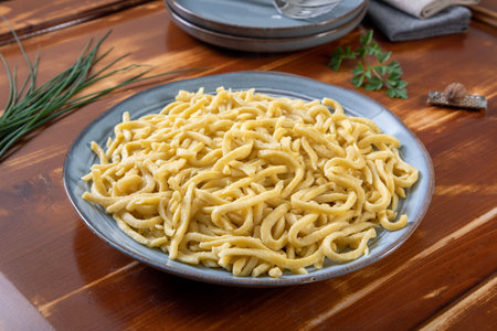 close up of a plate of italian pasta on a wooden tableの写真素材