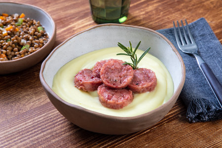 Lentil puree with meatballs in bowl on wooden tableの写真素材