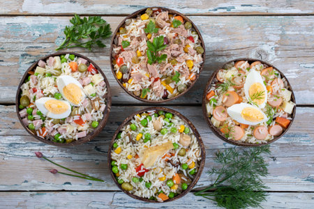 Rice with meat, vegetables and eggs in bowls on wooden backgroundの写真素材