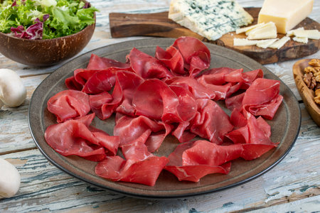 Italian prosciutto crudo or jamon with parmesan cheese and saladの写真素材