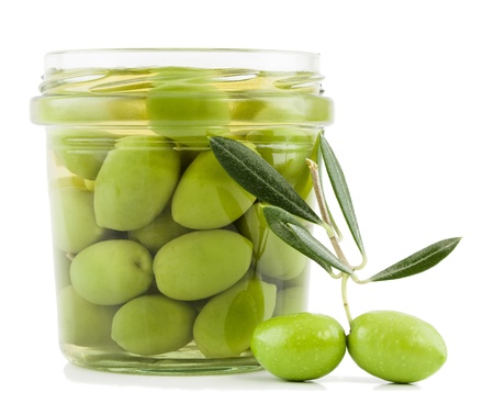 Pickled olives in glass jar and fresh olives on the branch  with leaves  isolated on a white background. の写真素材