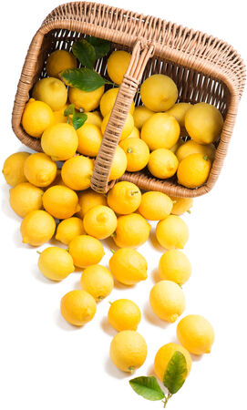  Lemons with leaves in a basket is scattered isolated on a on white の写真素材