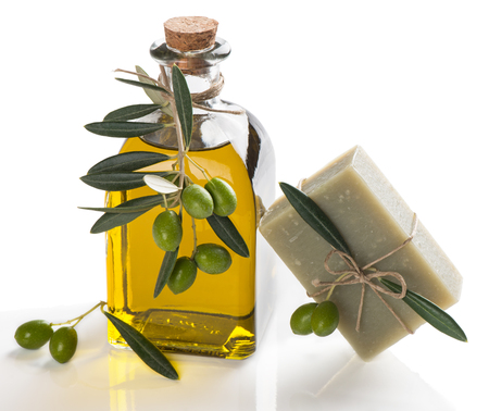   bath soap with olive oil and twigs of olive tree with green olives  isolated on whiteの写真素材
