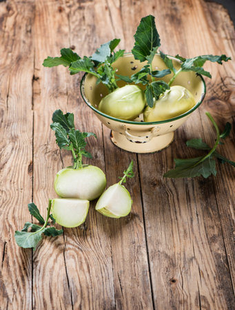 kohlrabi with leaves on wooden boardの写真素材