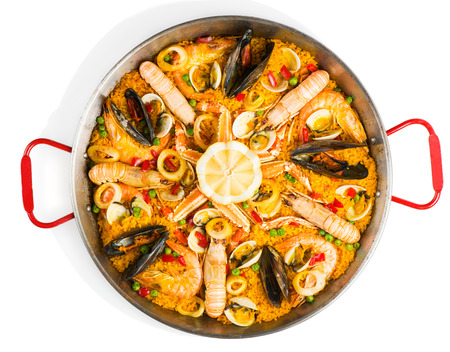 Top view of typical spanish seafood paella in traditional pan isolated on white backgroundの写真素材