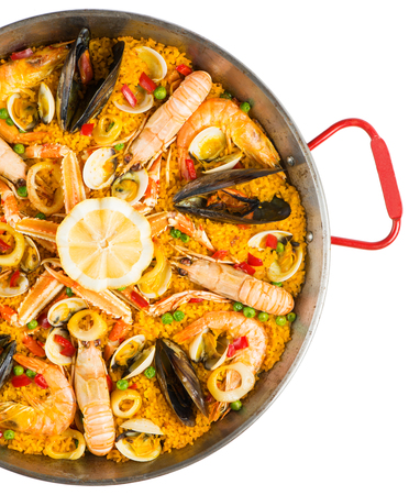 Spanish dish paella with seafood in traditional pan, view from above.  Isolated on a white background.の写真素材