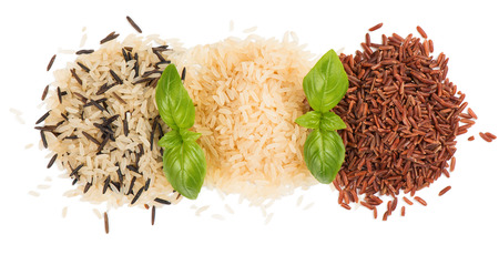 Top view of rice variety  (black rice, white rice, red rice) decorated with green basil isolated on white background.の写真素材