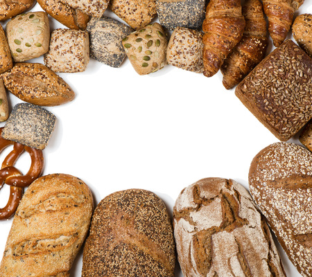 Top view of frame of bakery product assortment with bread loaves, buns, rolls, croissants and pretzels isolated on white background, space for text.の写真素材