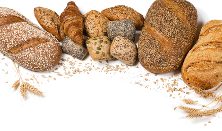 Frame of bakery product assortment with bread loaves, buns, rolls and croissants decorated with grains of sunflower, oat, flax, wheat and poppy isolated on white background.の写真素材