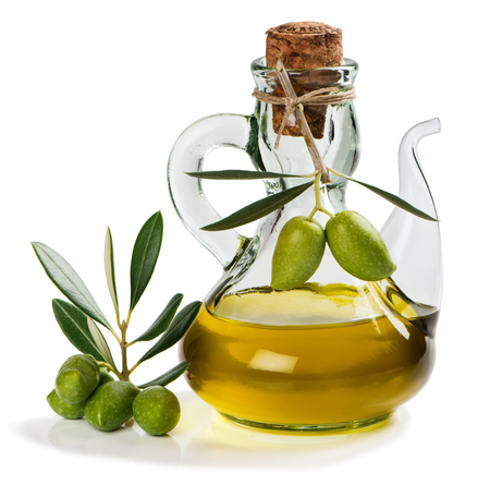 Branch with green olives and a bottle of olive oil isolated on white background.の写真素材