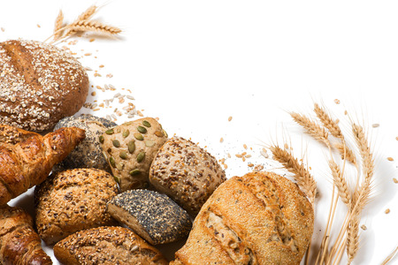 Top view of assortment of different kind of cereal bakery: bread, croissants, buns isolated on white background.の写真素材