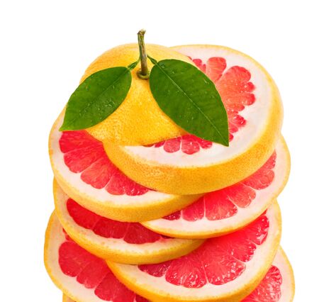 Slices of grapefruit and green leaves with drops isolated on white background.の写真素材