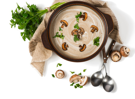Top view of open pan with mushroom cream soup decorated with whole and sliced champignons isolated on white background.の写真素材