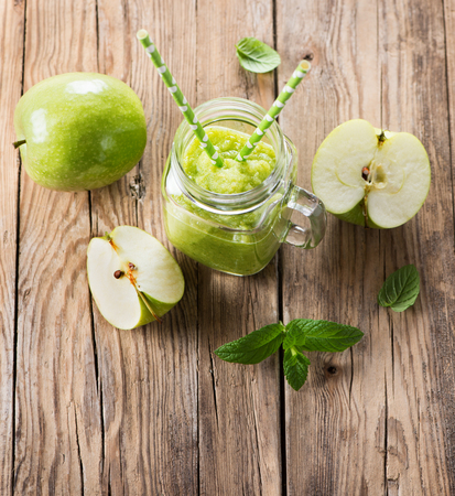 Top view of apple puree with mint in a jar mason on a rustic wooden background with copy space.の写真素材