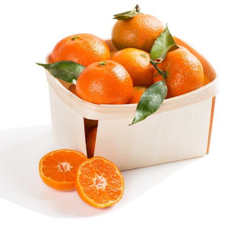 Crate of fresh clementines with leaves isolated on white background.の写真素材