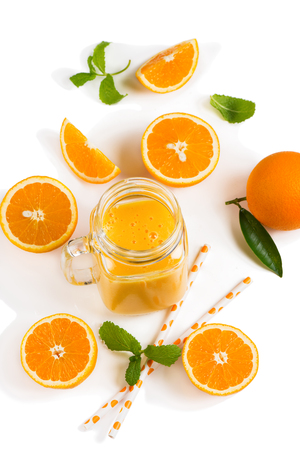 Top view of orange fruits and smoothie in a jar mug with straw isolated on white background.の写真素材