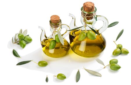 Two bottles of olive oil and fresh green olive fruits isolated on white background.の写真素材
