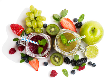 Top view of assortment of smoothies with ingredients - strawberry, raspberry, blueberry, blackberry, apple, kiwi, lime, limon, and grape isolated on white background. の写真素材