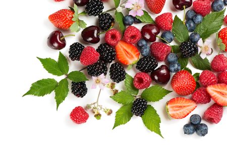 Top view of summer berries and fruits (strawberry, raspberry, blueberry, blackberry and cherry) with flowers and leaves isolated on white background.の写真素材