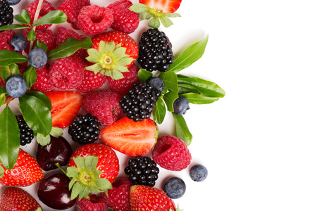   Mixed berries and fruits (strawberry, raspberry, blueberry, blackberry and cherry) and leaves isolated on white background. Above view.の写真素材