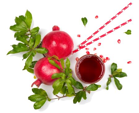 Top view of pomegranate fruits with green leaves and freshly squeezed pomegranate juice isolated on white background.の写真素材