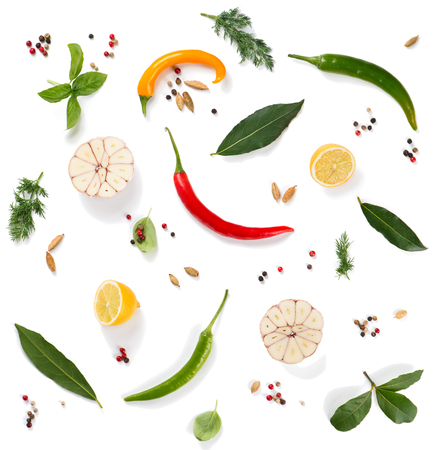 Top view of various herbs and spices ( pepper, basil, cardamom, bay leaf, garlic, lemon, dill and chilli ) isolated on white background. の写真素材