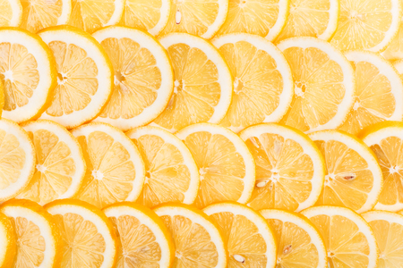 Lemon slices with seeds as background texture. Top view.の写真素材