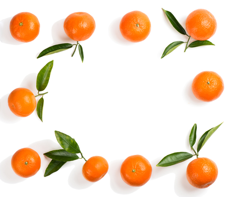  Frame of tangerines and green leaves isolated on a white background. Top view.の写真素材