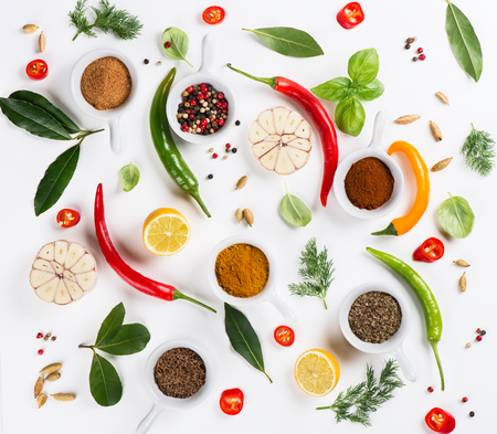 Top view of different spices and seasoning ingredients over white background.の写真素材
