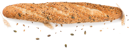 Top view of bread topped with different seeds, such as pumpkin, flax, sunflower, sesame, millet and poppyseeds decorated with wheat ears isolated on white background.の写真素材