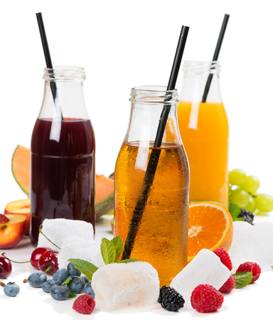 Various cold juices, ice, fruits and berries - raspberry, blueberry, blackberry, nectarine, melon, and grape isolated on white background. Summer concept.の写真素材