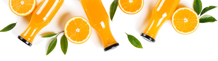 Flat lay, top view of compocition of orange juice in a glass  bottles and orange slices with green leaves isolated on white background.の写真素材