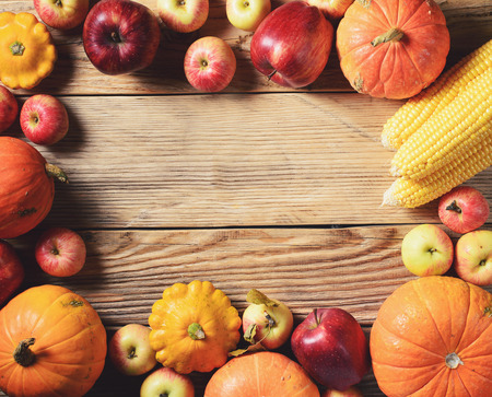 Autumn concept - pumpkins with colorful vegetables on wooden background. Copy-spaceの写真素材