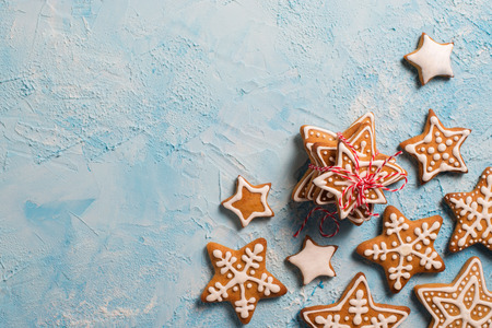 Frame of gingerbreads stars over blue texture
