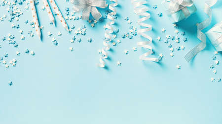 Birthday and party concept background with decoration on blue, top view, copy space, bannerの写真素材
