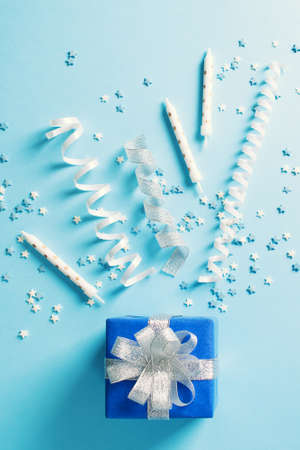 Birthday and party concept background with decoration on blue, top view, copy spaceの写真素材