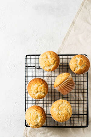 Homemade tasty miffins on white background, copy space, top view, verticalの写真素材