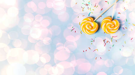 Concept of birthday and party with lollipop on blue pastel bakground, top view, copy space, bannerの写真素材